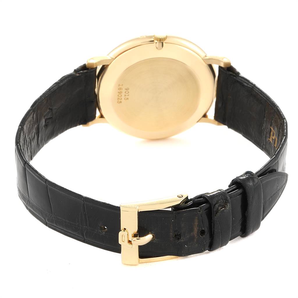 The image shows the back view of the Piaget 9015 Women's Yellow Gold Green Dial 9015 Women's Yellow Gold Green Dial 9015 Yellow Gold Malachite Dial Vintage Ladies Watch and its black leather strap.