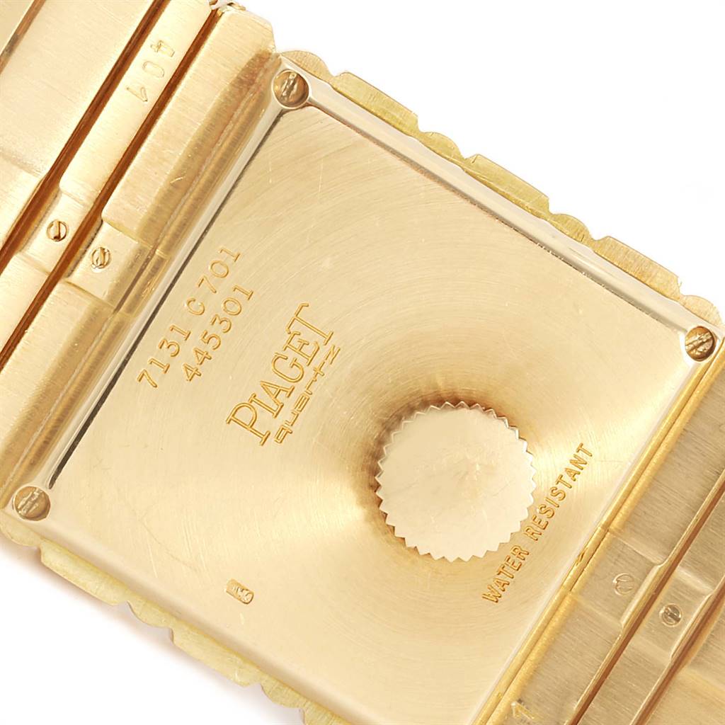This close-up image of the Piaget 7131 C 701 Men's Yellow Gold Champagne Dial 7131 C 701 Men's Yellow Gold Champagne Dial Polo 18K Yellow Gold Men's Watch 7131 model shows the back case and part of the bracelet.