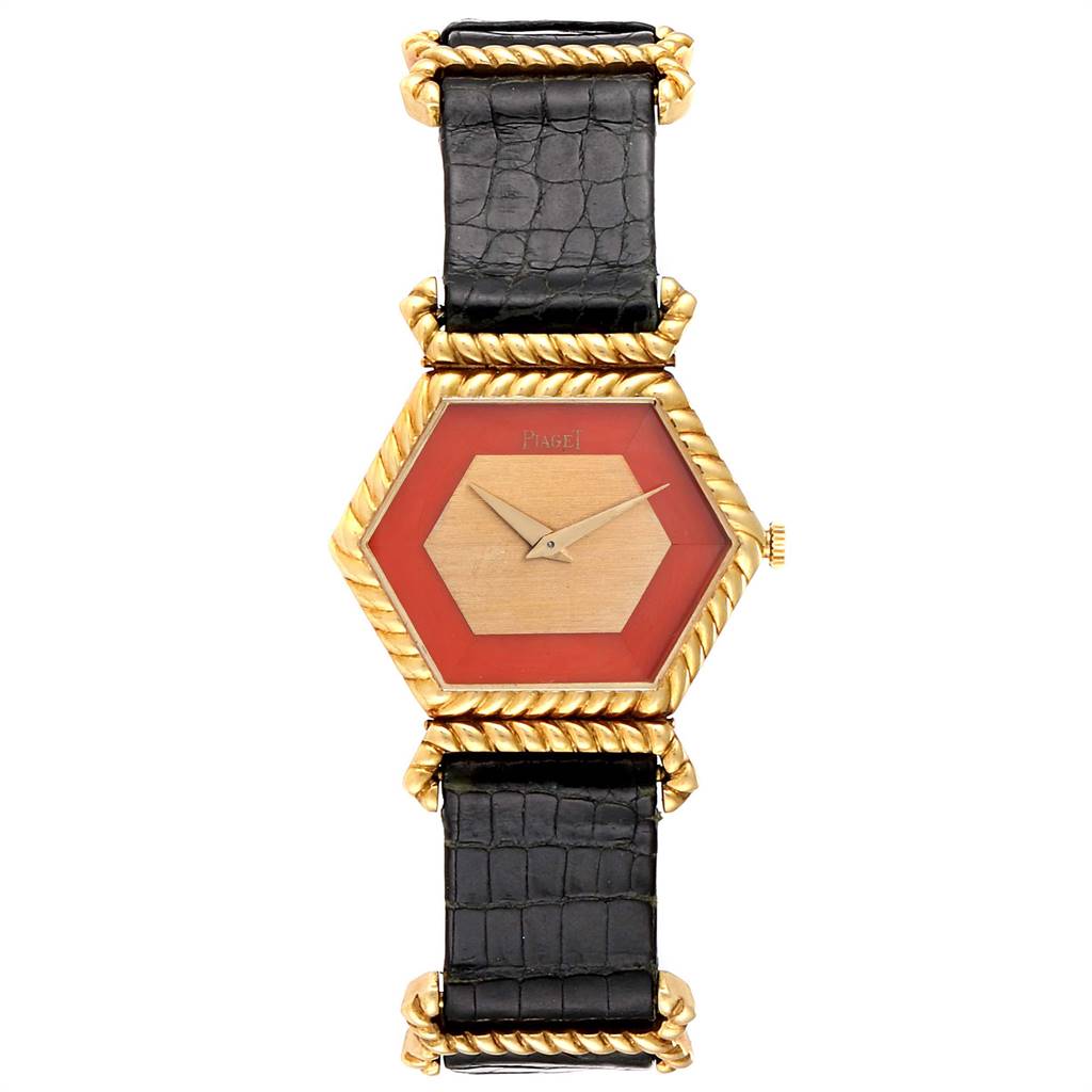 This image shows a top view of the Piaget 9559 Women's Yellow Gold Pink Dial 9559 Women's Yellow Gold Pink Dial 9559 model watch, featuring a hexagonal coral dial and 18K yellow gold case with a black strap.