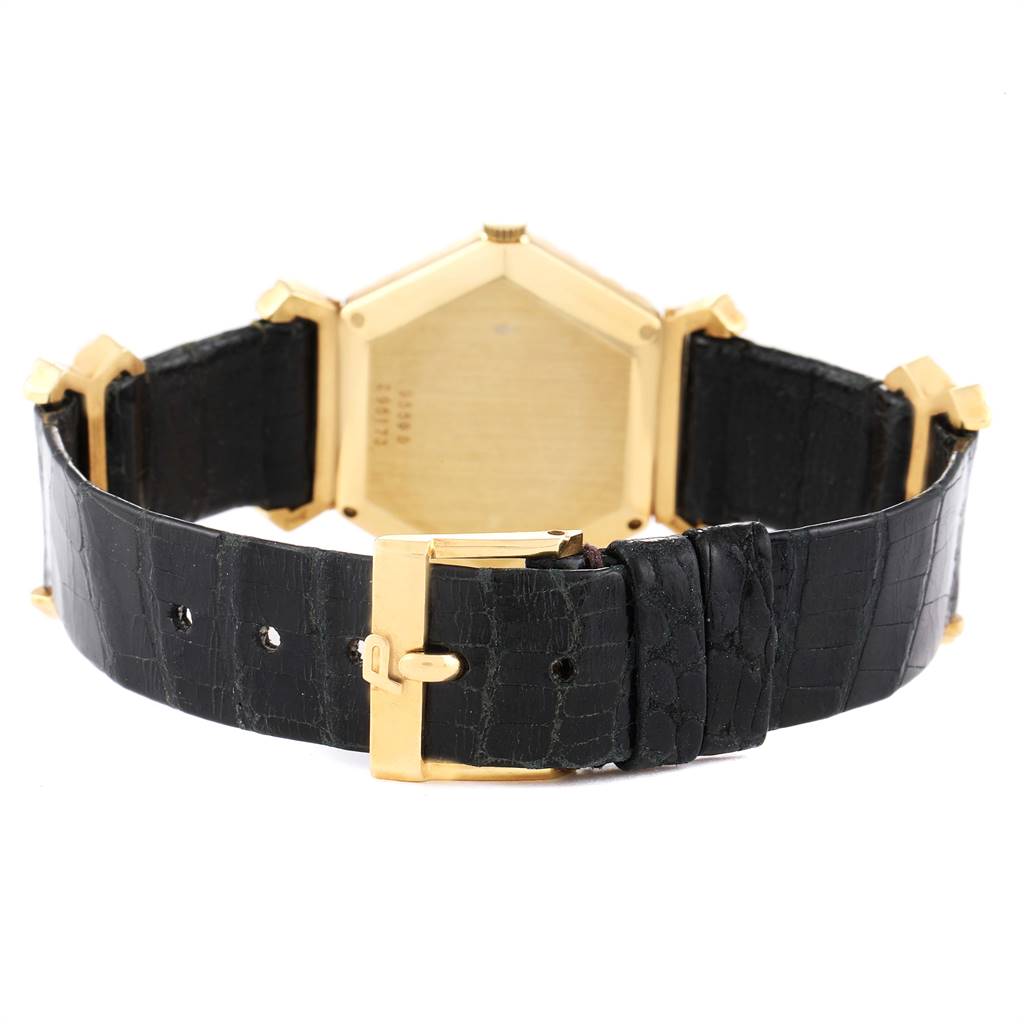 The image shows the back view of the Piaget 9559 Women's Yellow Gold Pink Dial 9559 Women's Yellow Gold Pink Dial 18K Yellow Gold Coral Dial Hexagonal Vintage Ladies Watch 9559, including its clasp, strap, and case back.