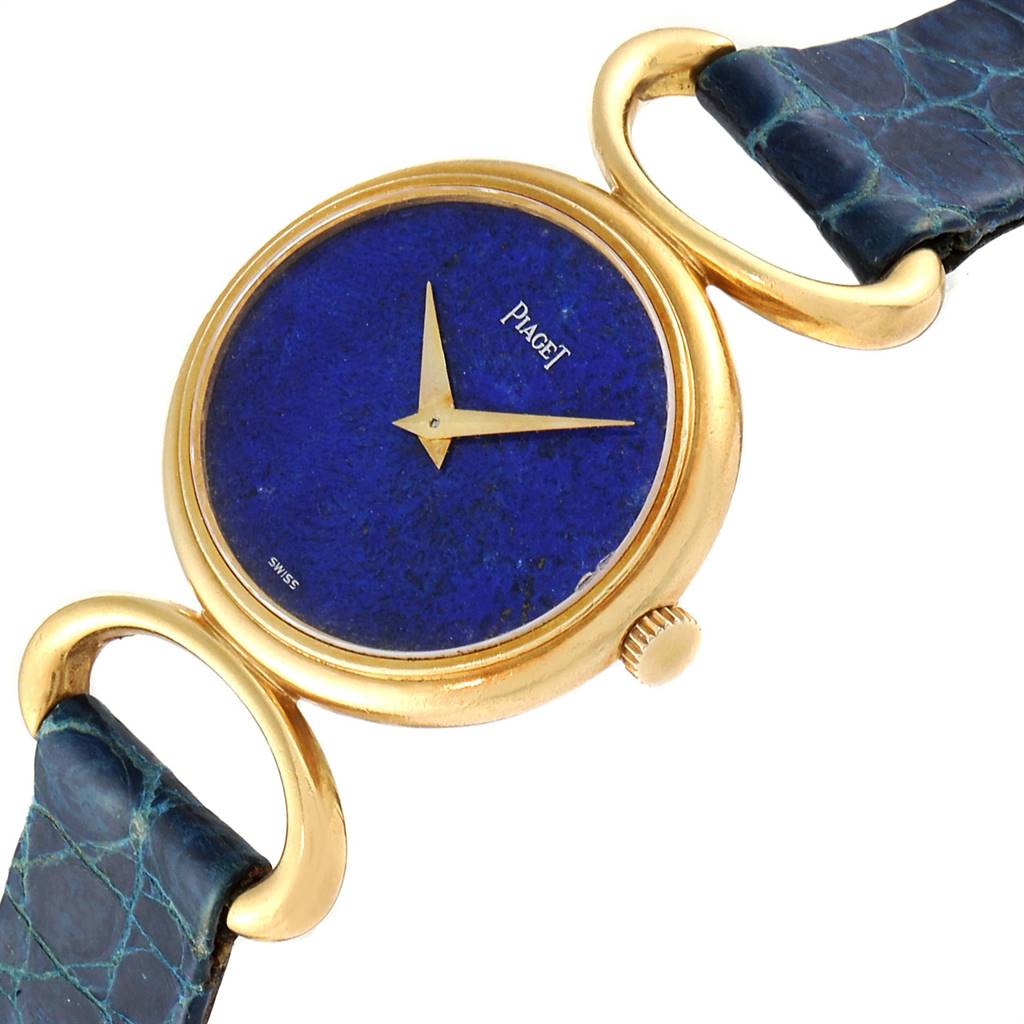 The Piaget 9451 Women's Yellow Gold Blue Dial 9451 Women's Yellow Gold Blue Dial Classique 9451 model is shown at an angle highlighting its yellow gold case, lapis dial, crown, and part of the strap.