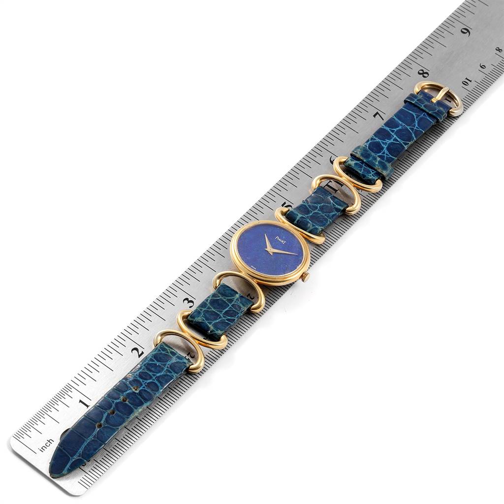 The Piaget 9451 Women's Yellow Gold Blue Dial 9451 Women's Yellow Gold Blue Dial Classique Yellow Gold Lapis Dial Vintage Ladies Watch 9451 is shown flat, with the dial, strap, and a ruler for scale.