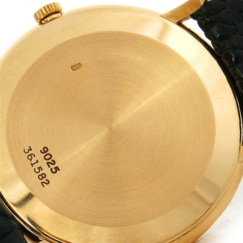 This image shows the back case of the Piaget 9025 Men's Yellow Gold White Dial 9025 Men's Yellow Gold White Dial 9025 18K Yellow Gold Mechanical Men's Watch, including the crown and strap attachments.