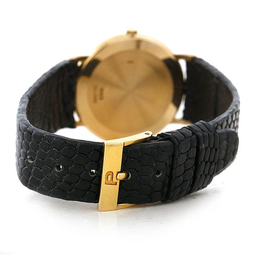 The image shows the back view of the Piaget 9025 Men's Yellow Gold White Dial 9025 Men's Yellow Gold White Dial 18K Yellow Gold Mechanical Men's Watch 9025, focusing on the buckle and leather strap.