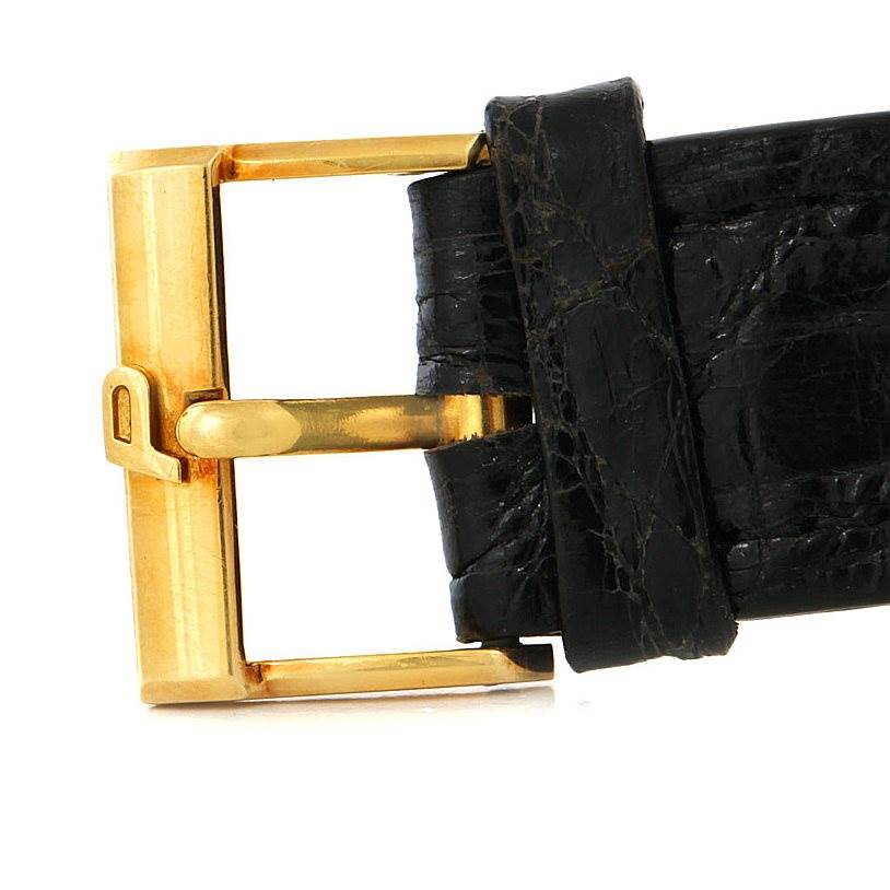 The image shows the gold buckle and part of the black leather strap of the Piaget Men's Yellow Gold Black Dial Men's Yellow Gold Black Dial 18K Yellow Gold Cushion Shape Mechanical Men's Watch.