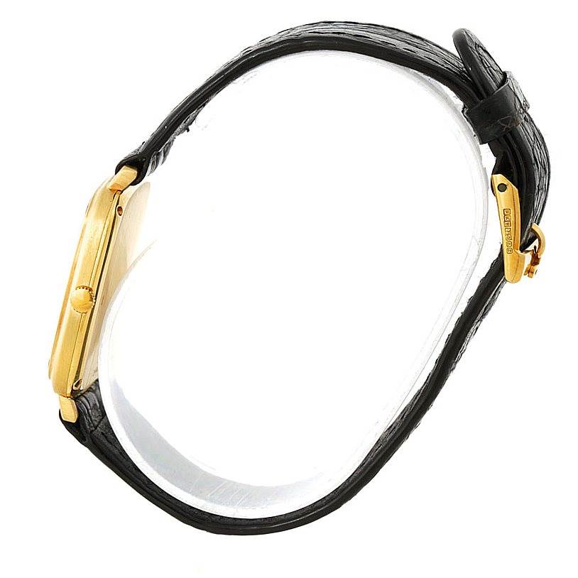 The image shows a side view of the Piaget Men's Yellow Gold Black Dial Men's Yellow Gold Black Dial 18K Yellow Gold Cushion Shape Mechanical Mens Watch, highlighting its strap and clasp.