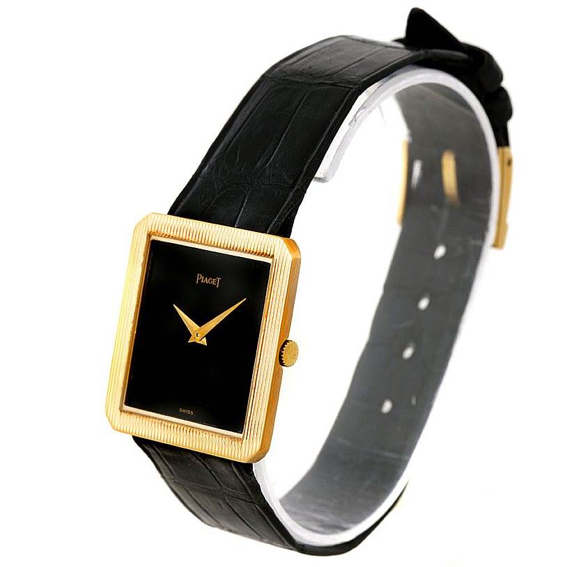 The image shows a side-angle view of the Piaget 9154 Men's Yellow Gold Black Dial 9154 Men's Yellow Gold Black Dial 9154 model, featuring its 18K yellow gold cushion-shaped case and black leather strap.