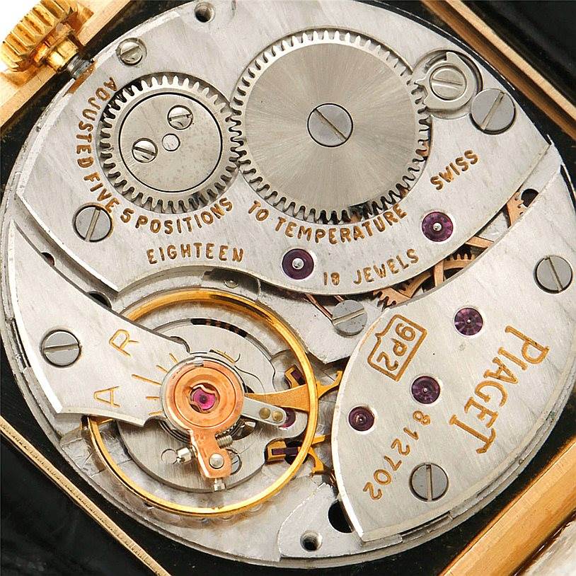 This image shows the intricate internal mechanism of the Piaget 9154 Men's Yellow Gold Black Dial 9154 Men's Yellow Gold Black Dial 9154 18K Yellow Gold Cushion Shape men's watch from a close-up angle.