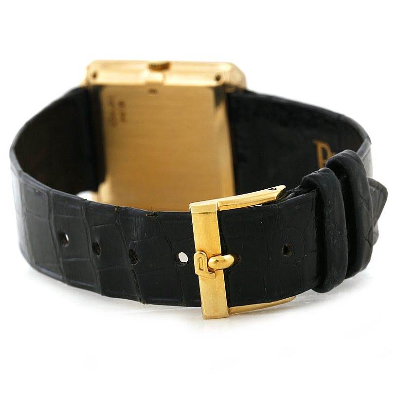 This image shows the back of a Piaget 9154 Men's Yellow Gold Black Dial 9154 Men's Yellow Gold Black Dial 9154 model 18K Yellow Gold Cushion Shape Men's Watch, focusing on the buckle and strap.