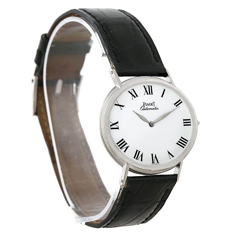 The image shows a Piaget 12501 Men's White Gold White Dial 12501 Men's White Gold White Dial 12501 18K White Gold Automatic Men's Watch at a slight side angle, highlighting the face and black leather strap.