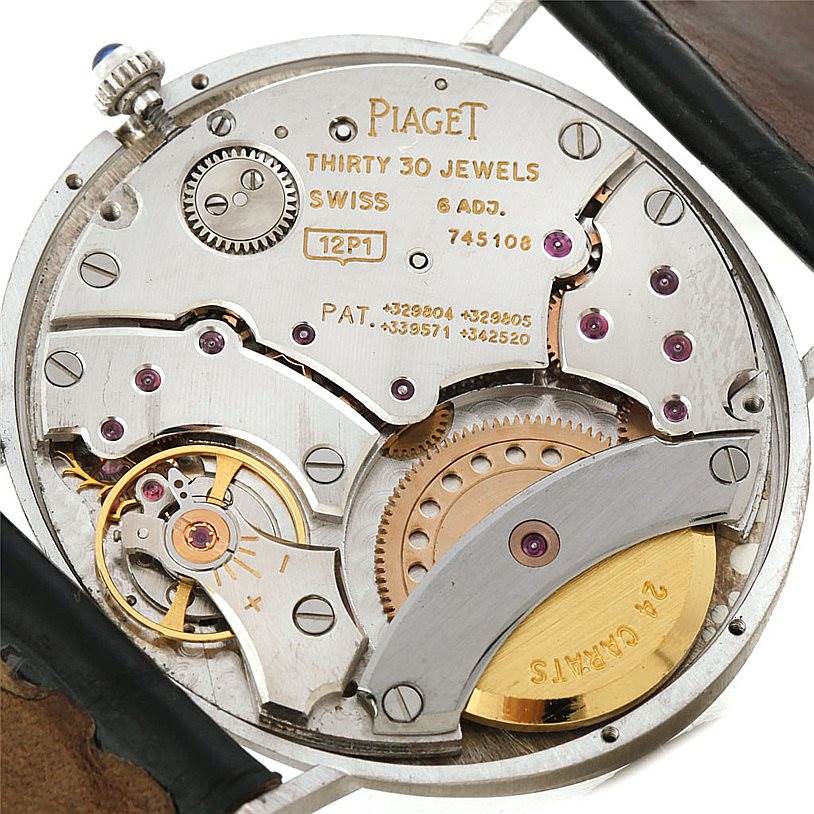 This image shows the back view of the Piaget 12501 Men's White Gold White Dial 12501 Men's White Gold White Dial 12501 model, displaying its intricate inner mechanism and parts.