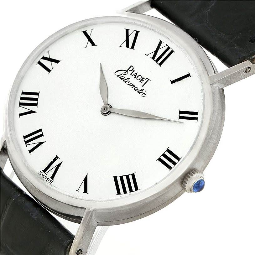 The image shows a close-up of the dial, crown, and part of the strap of the Piaget 12501 Men's White Gold White Dial 12501 Men's White Gold White Dial 18K White Gold Automatic Mens Watch model 12501.