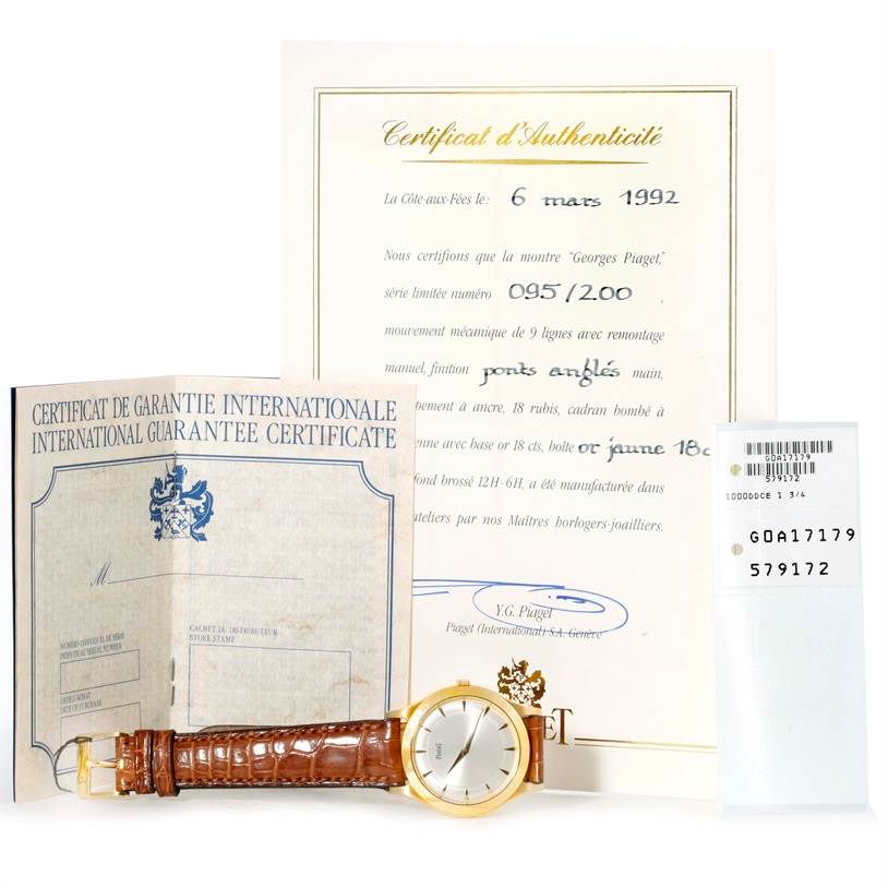 The image shows the Piaget 91000 Men's Yellow Gold Silver Dial 91000 Men's Yellow Gold Silver Dial 91000 model watch along with its Certificates of Authenticity and International Guarantee.