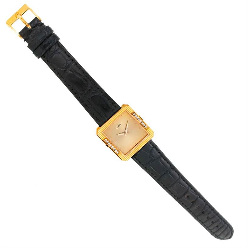 The Piaget Men's Yellow Gold Champagne Dial Men's Yellow Gold Champagne Dial 18K Yellow Gold Cushion Shape Diamond Mechanical Men's Watch is shown from a front angle, displaying the dial, case, and strap.