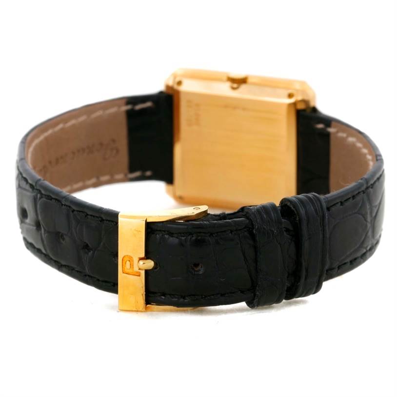 This image shows the back view of the Piaget Men's Yellow Gold Champagne Dial Men's Yellow Gold Champagne Dial 18K Yellow Gold Cushion Shape Diamond Mechanical Men's Watch, highlighting the clasp and strap.