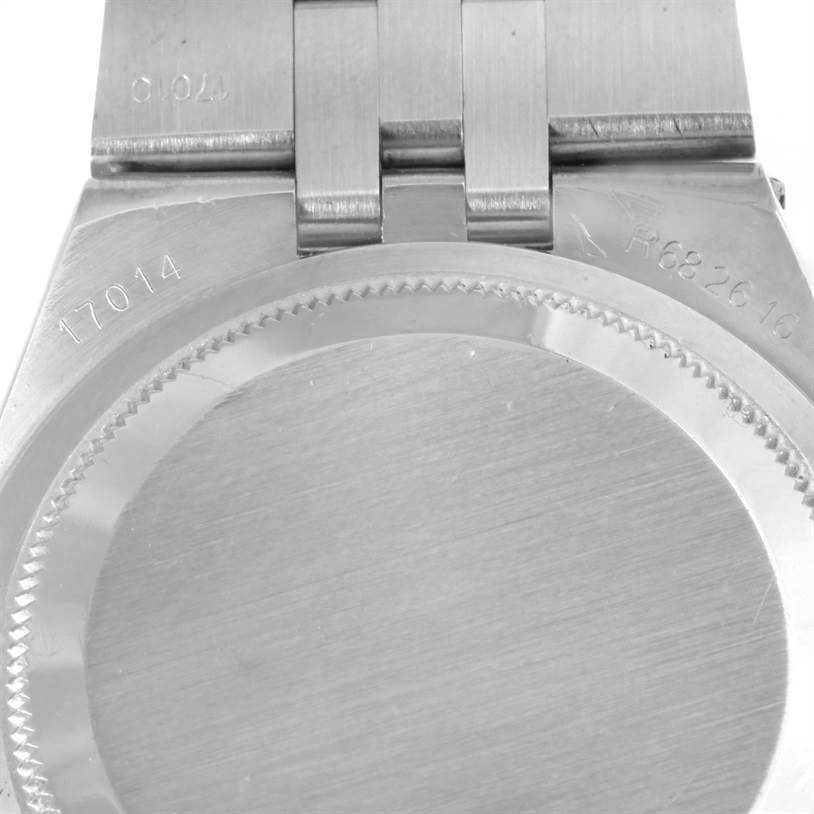 The image shows a close-up of the back case and part of the bracelet of a Rolex Oysterquartz 17014 Men's Stainless Steel White Dial 17014 Men's Stainless Steel White Dial watch.