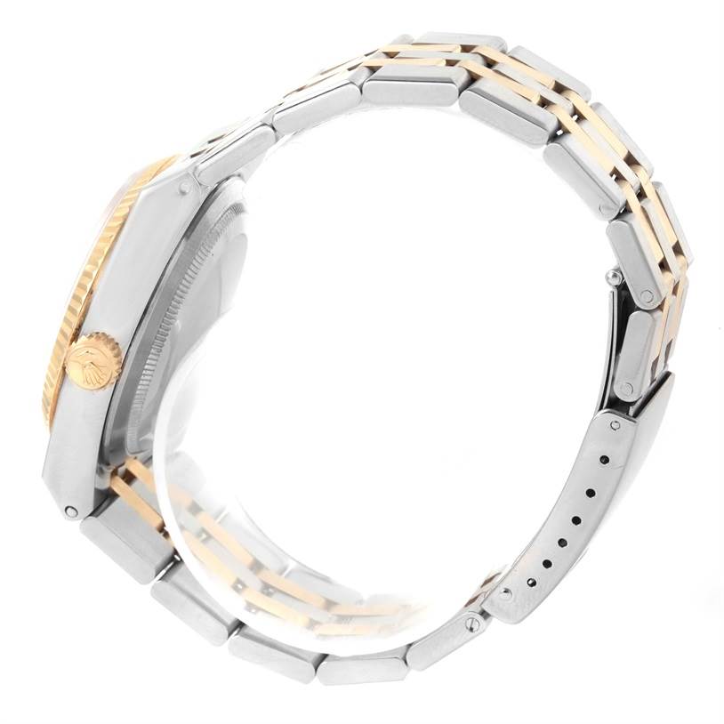 The image shows a side view of a Rolex Oysterquartz 17013 Men's Stainless Steel White Dial 17013 Men's Stainless Steel White Dial watch, highlighting its two-tone metal bracelet and crown.