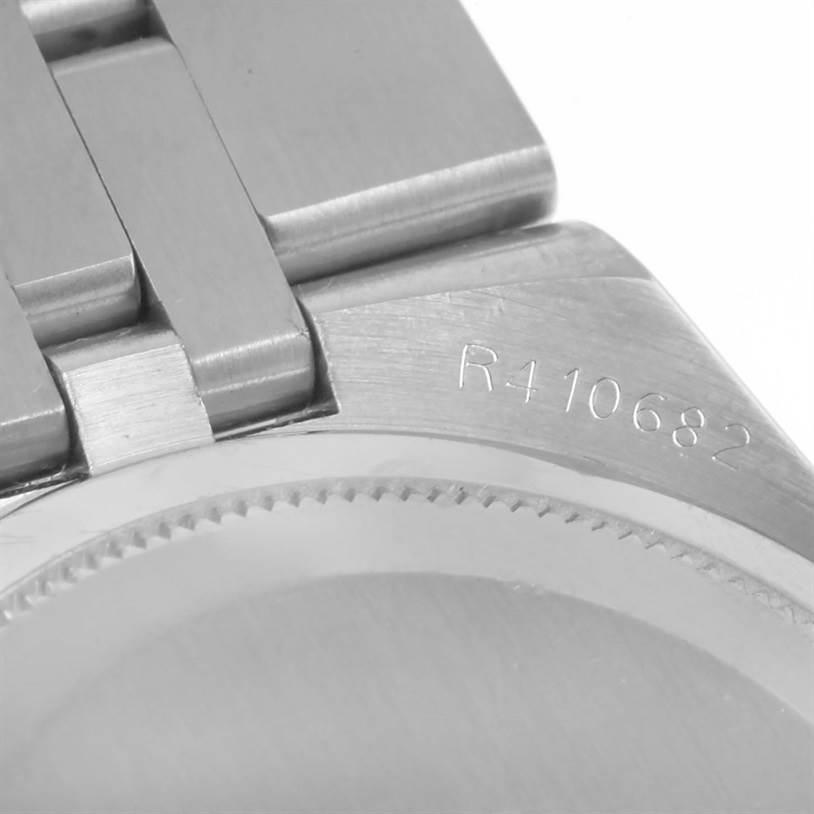This image shows a close-up of the Rolex Oysterquartz 17014 Men's Stainless Steel White Dial 17014 Men's Stainless Steel White Dial watch's bracelet and caseback with a visible serial number.