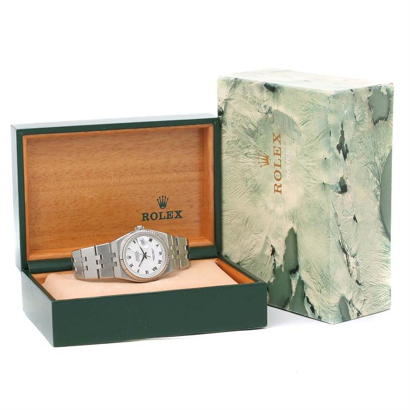 The Rolex Oysterquartz 17014 Men's Stainless Steel White Dial 17014 Men's Stainless Steel White Dial watch is shown in an open green and wooden box, with the watch displayed at an angled front view.