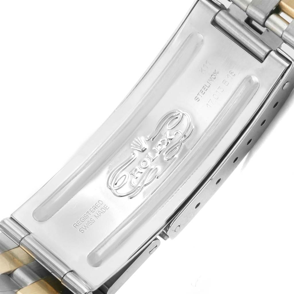 The image shows the clasp of a Rolex Oysterquartz 17013 Men
s Stainless Steel Champagne Dial 17013 Men
s Stainless Steel Champagne Dial watch, highlighting the brand and model engravings.