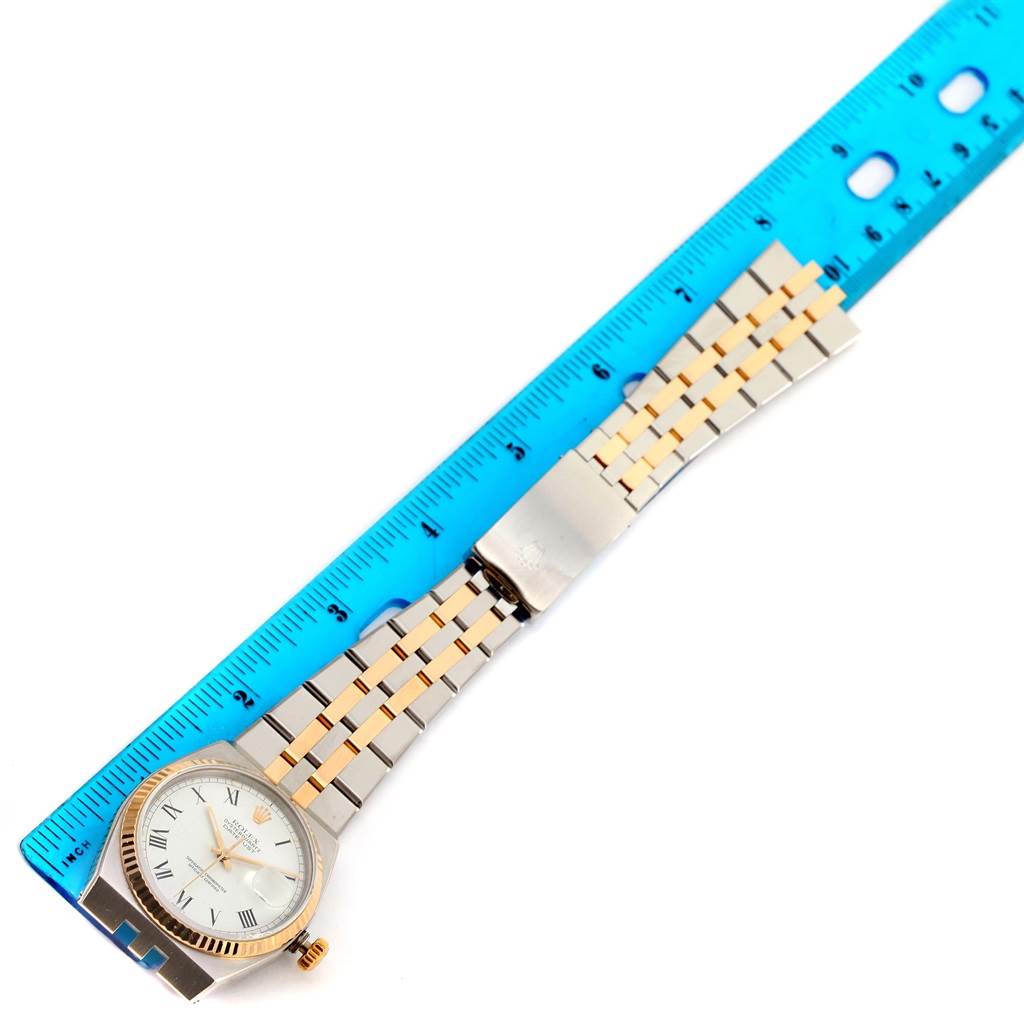 The image shows a Rolex Oysterquartz 17013 Men's Stainless Steel White Dial 17013 Men's Stainless Steel White Dial watch laid flat with a blue ruler measuring its band length.