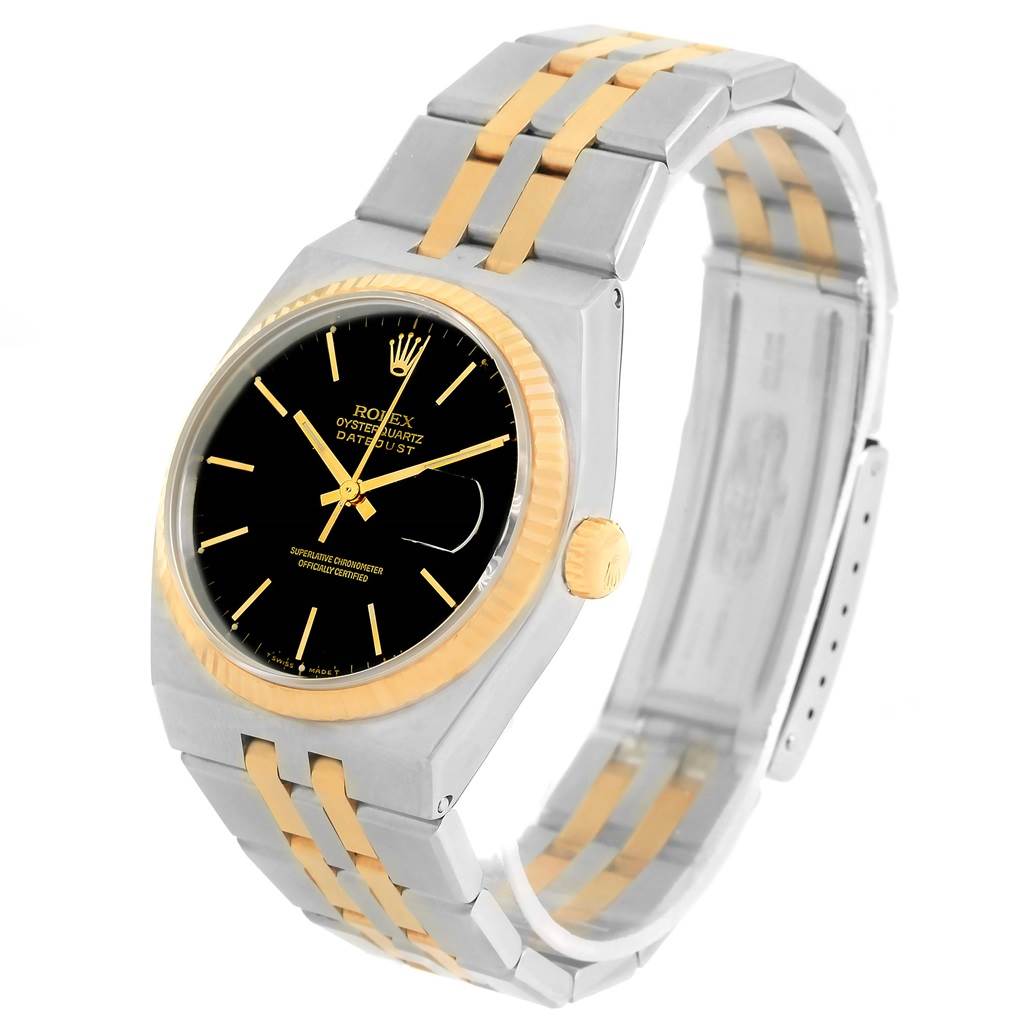 The image shows a Rolex Oysterquartz 17013 Men
s Stainless Steel Black Dial 17013 Men
s Stainless Steel Black Dial watch from a three-quarter angle, highlighting the black dial, gold bezel, and two-tone bracelet.