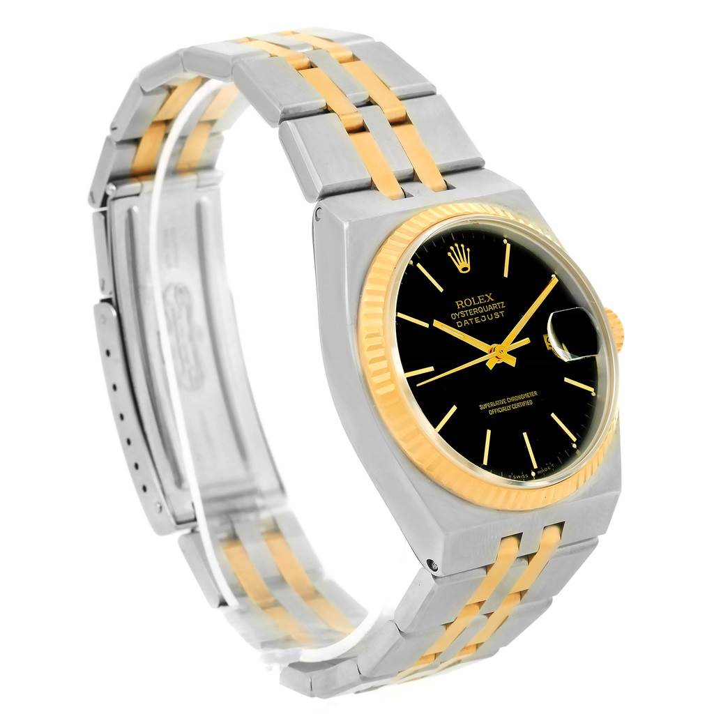 The image shows the Rolex Oysterquartz 17013 Men
s Stainless Steel Black Dial 17013 Men
s Stainless Steel Black Dial model at an angle displaying its gold and silver bracelet, black dial, and fluted bezel.