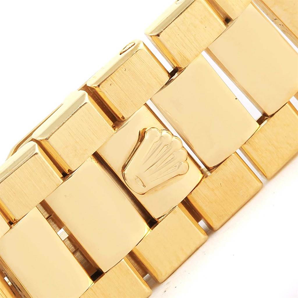 This image shows a close-up of the gold bracelet of a Rolex Oysterquartz 19018 Men's Stainless Steel Brown Dial 19018 Men's Stainless Steel Brown Dial watch, highlighting the Rolex logo on the clasp.