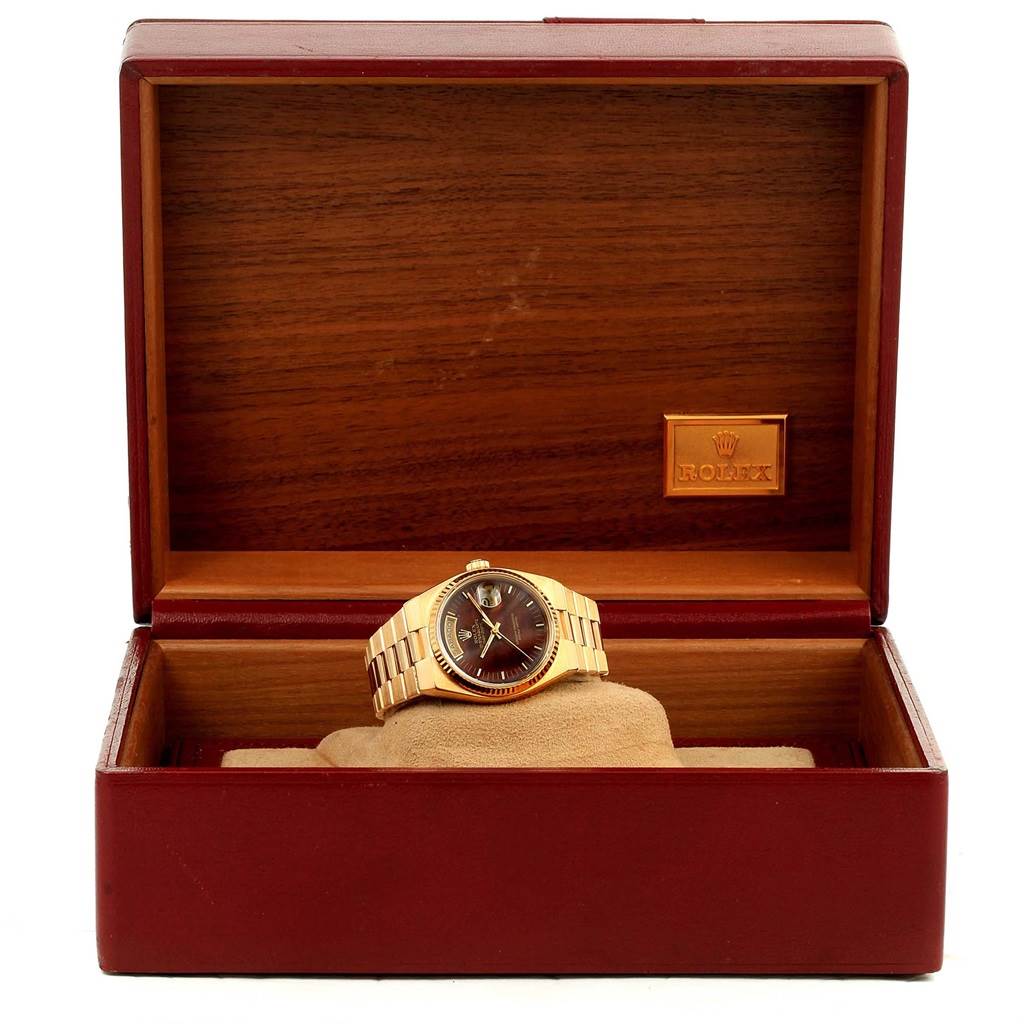 The Rolex Oysterquartz 19018 Men's Stainless Steel Brown Dial 19018 Men's Stainless Steel Brown Dial watch is displayed in a wooden open box, showing the full watch from the front with a clear view of the dial and band.