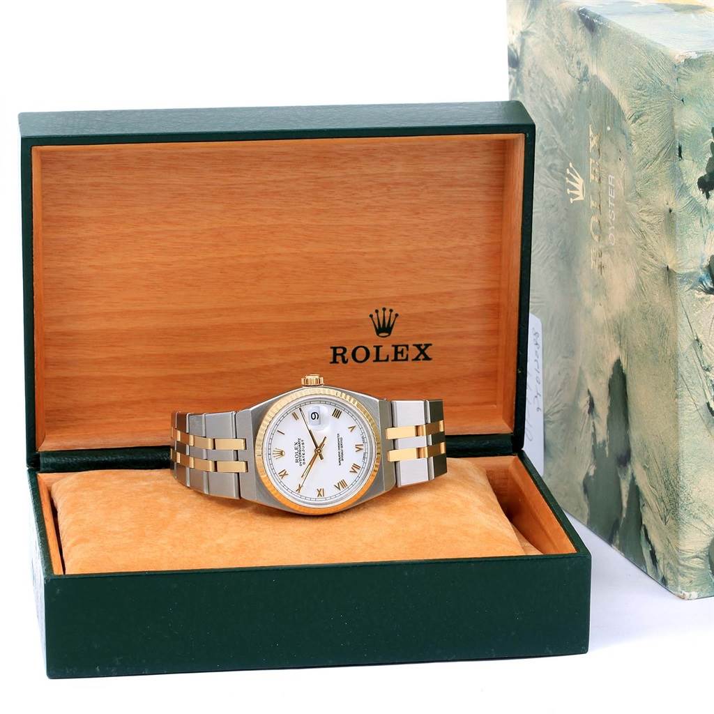 The image shows a Rolex Oysterquartz 17013 Men
s Stainless Steel White Dial 17013 Men
s Stainless Steel White Dial watch placed in an open wooden box with its packaging visible beside it.