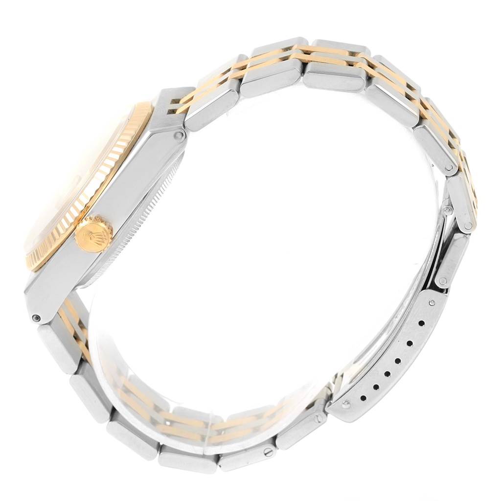 The image shows a side view of a Rolex Oysterquartz 17013 Men's Stainless Steel Champagne Dial 17013 Men's Stainless Steel Champagne Dial watch, highlighting the bezel, crown, and two-tone bracelet.