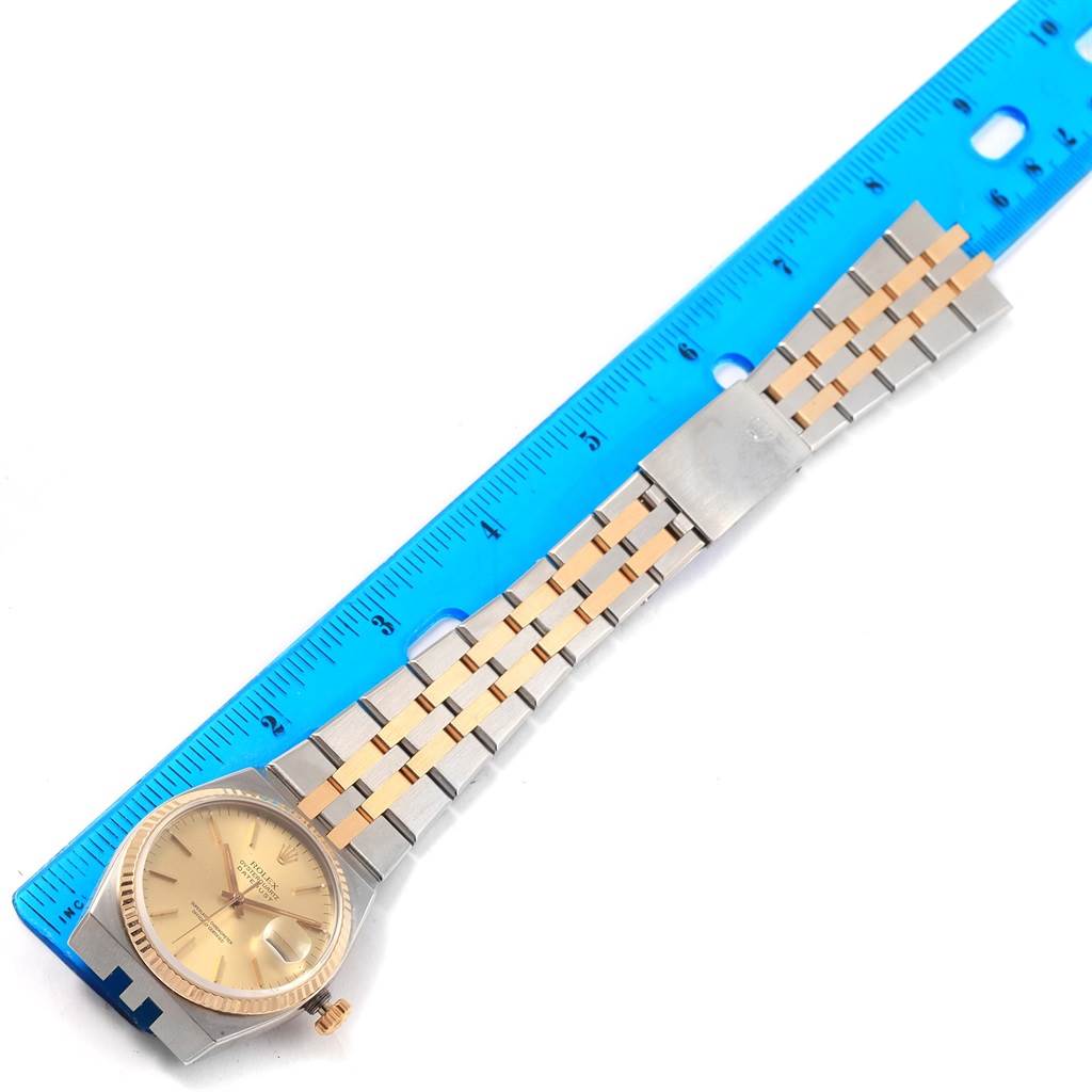 The image shows a top-down view of a Rolex Oysterquartz 17013 Men's Stainless Steel Champagne Dial 17013 Men's Stainless Steel Champagne Dial watch with a ruler for scale.