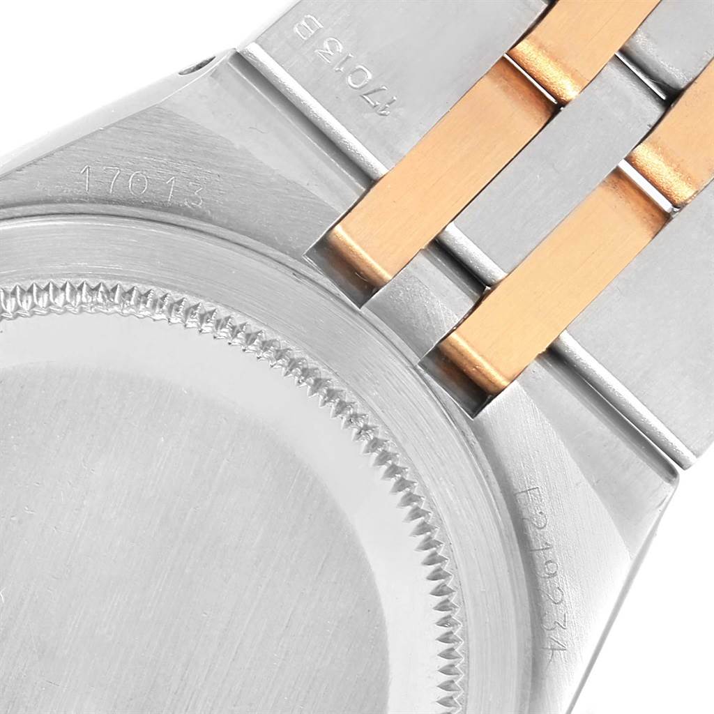 The image shows the back case and part of the bracelet of a Rolex Oysterquartz 17013 Men
s Stainless Steel Champagne Dial 17013 Men
s Stainless Steel Champagne Dial model.