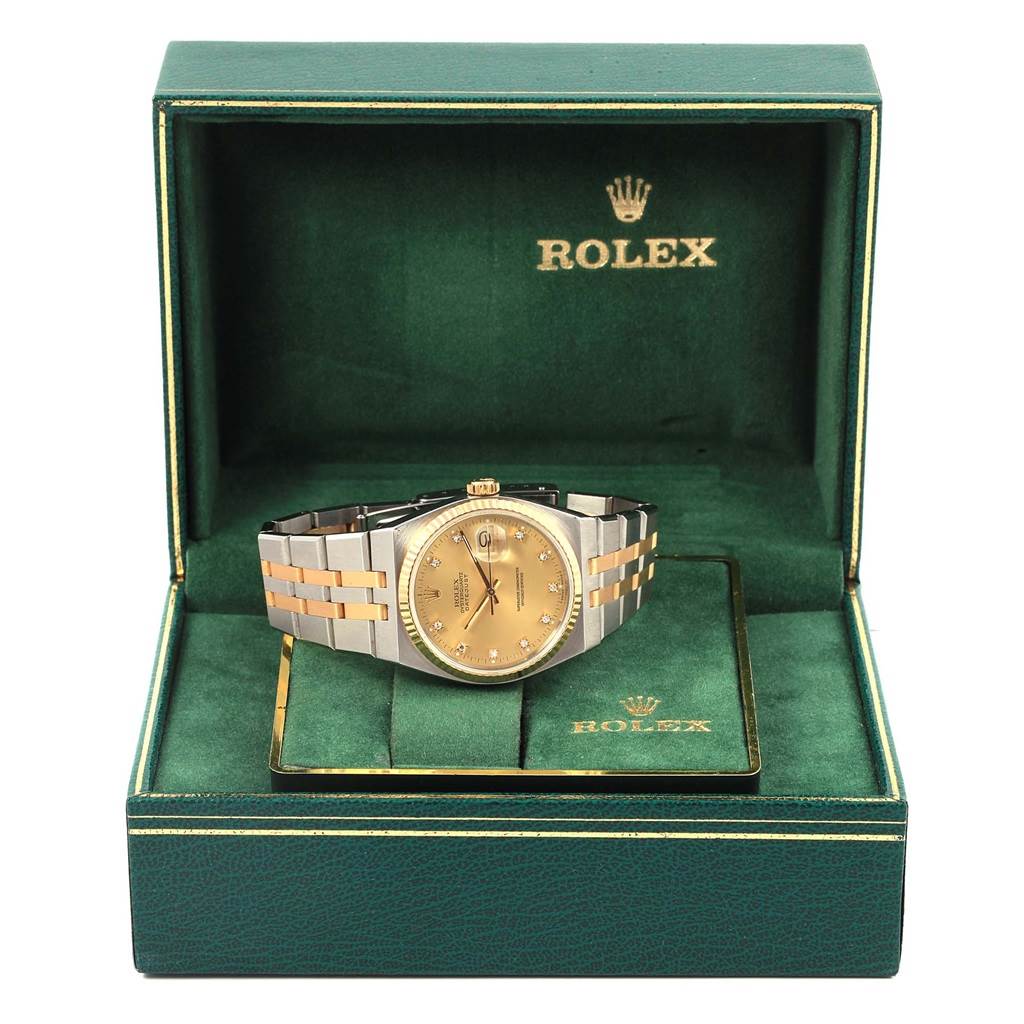 The Rolex Oysterquartz 17013 Men
s Stainless Steel Champagne Dial 17013 Men
s Stainless Steel Champagne Dial watch is shown from the front in its green branded box with the lid open.