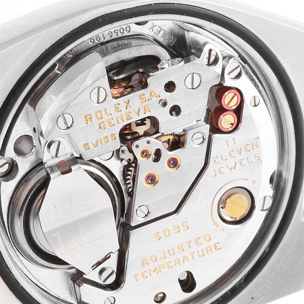 The image shows a close-up of the movement mechanism inside a Rolex Oysterquartz 17000 Men's Stainless Steel Black Dial 17000 Men's Stainless Steel Black Dial watch, highlighting its intricate components and engravings.