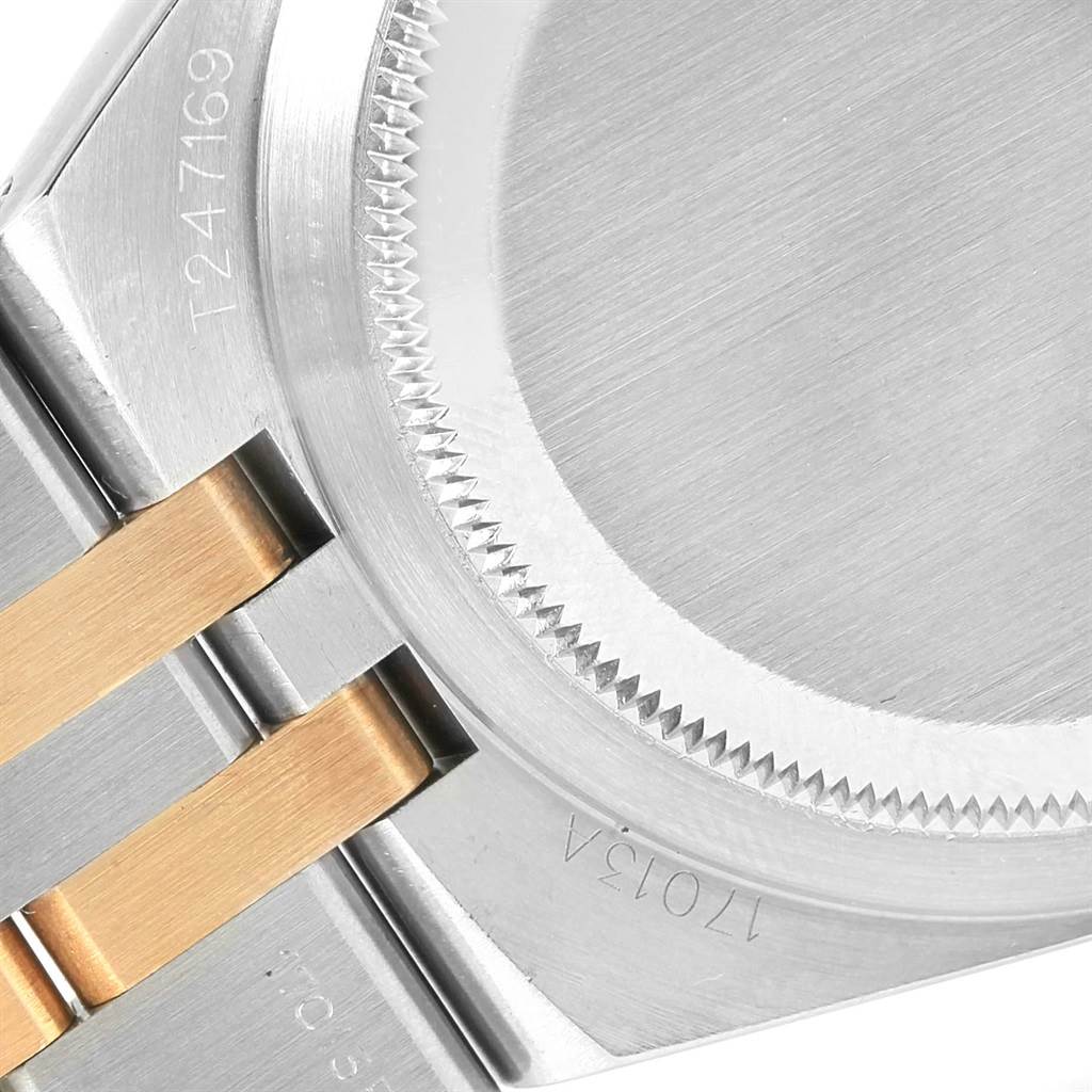 This image shows a close-up of the case back and part of the bracelet of the Rolex Oysterquartz 17013 Men's Stainless Steel White Dial 17013 Men's Stainless Steel White Dial watch.