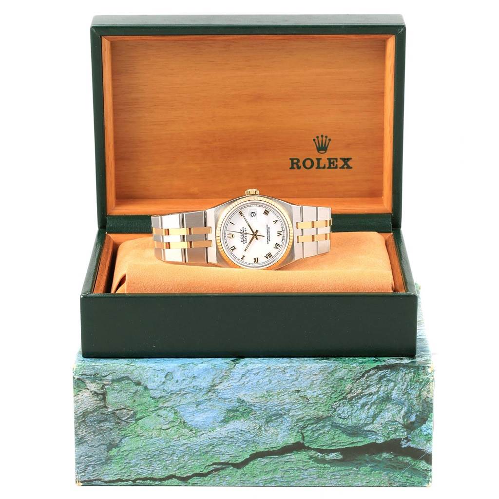 The Rolex Oysterquartz 17013 Men's Stainless Steel White Dial 17013 Men's Stainless Steel White Dial watch is shown from a front angle, displayed in its green and brown box, highlighting the dial and bracelet.