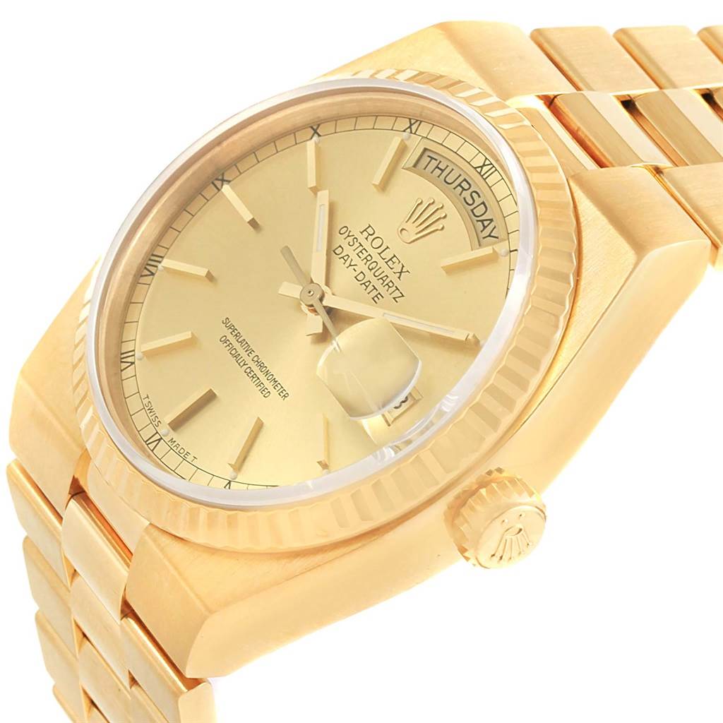 This image shows a close-up angle of the Rolex Oysterquartz 19018 Men's Yellow Gold Champagne Dial 19018 Men's Yellow Gold Champagne Dial watch, displaying the dial, bezel, part of the bracelet, and crown.