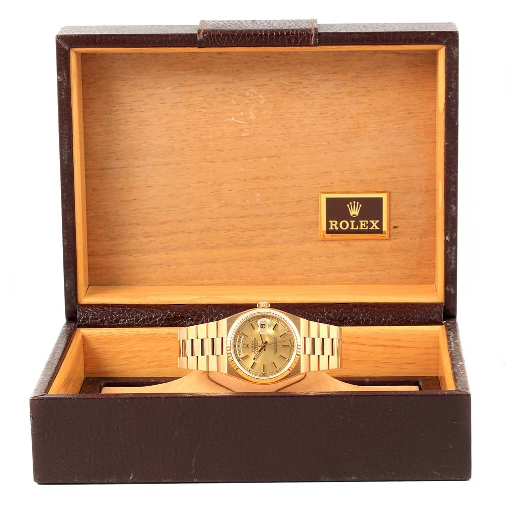 The Rolex Oysterquartz 19018 Men's Yellow Gold Champagne Dial 19018 Men's Yellow Gold Champagne Dial watch is displayed head-on inside a wooden box with a leather exterior and the Rolex logo on the lid.