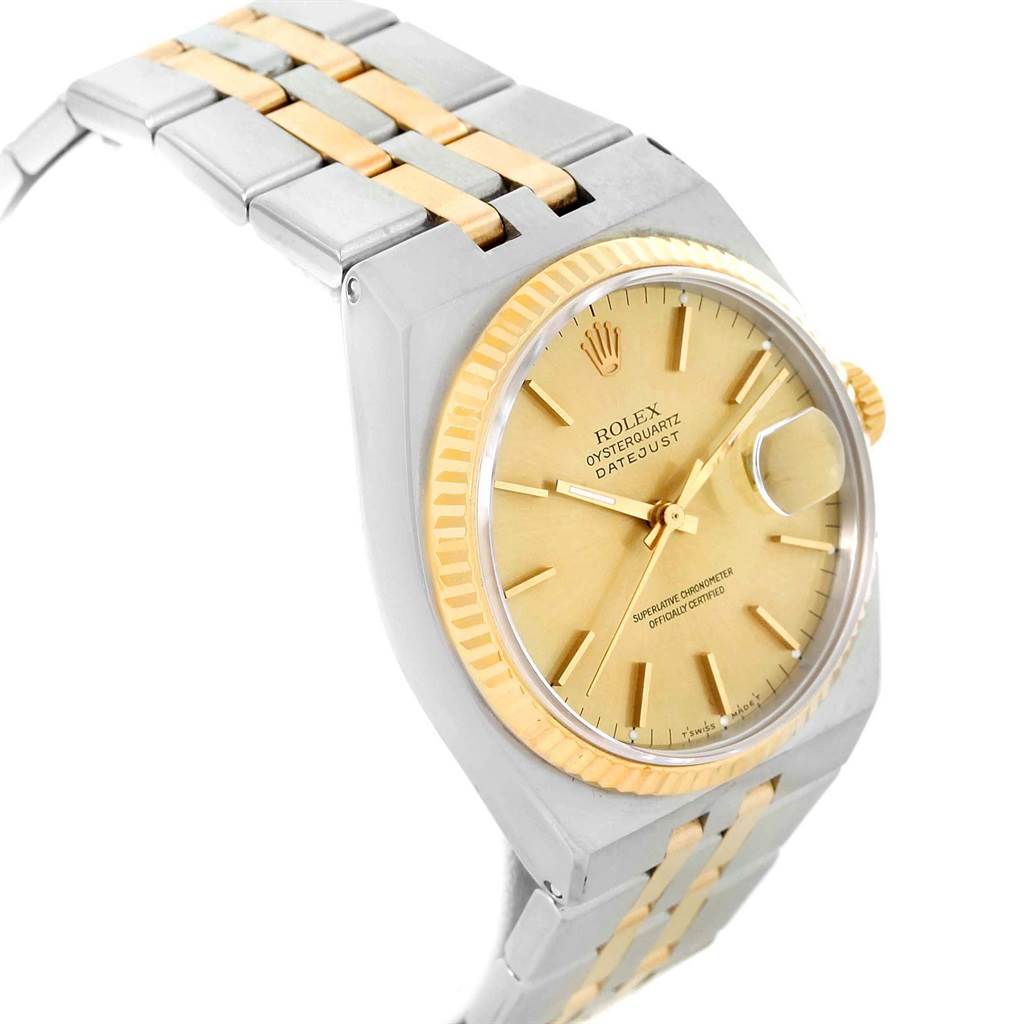 The Rolex Oysterquartz 17013 Men's Stainless Steel Champagne Dial 17013 Men's Stainless Steel Champagne Dial watch is shown from a slight side angle, displaying its gold and silver bracelet, face, and bezel.