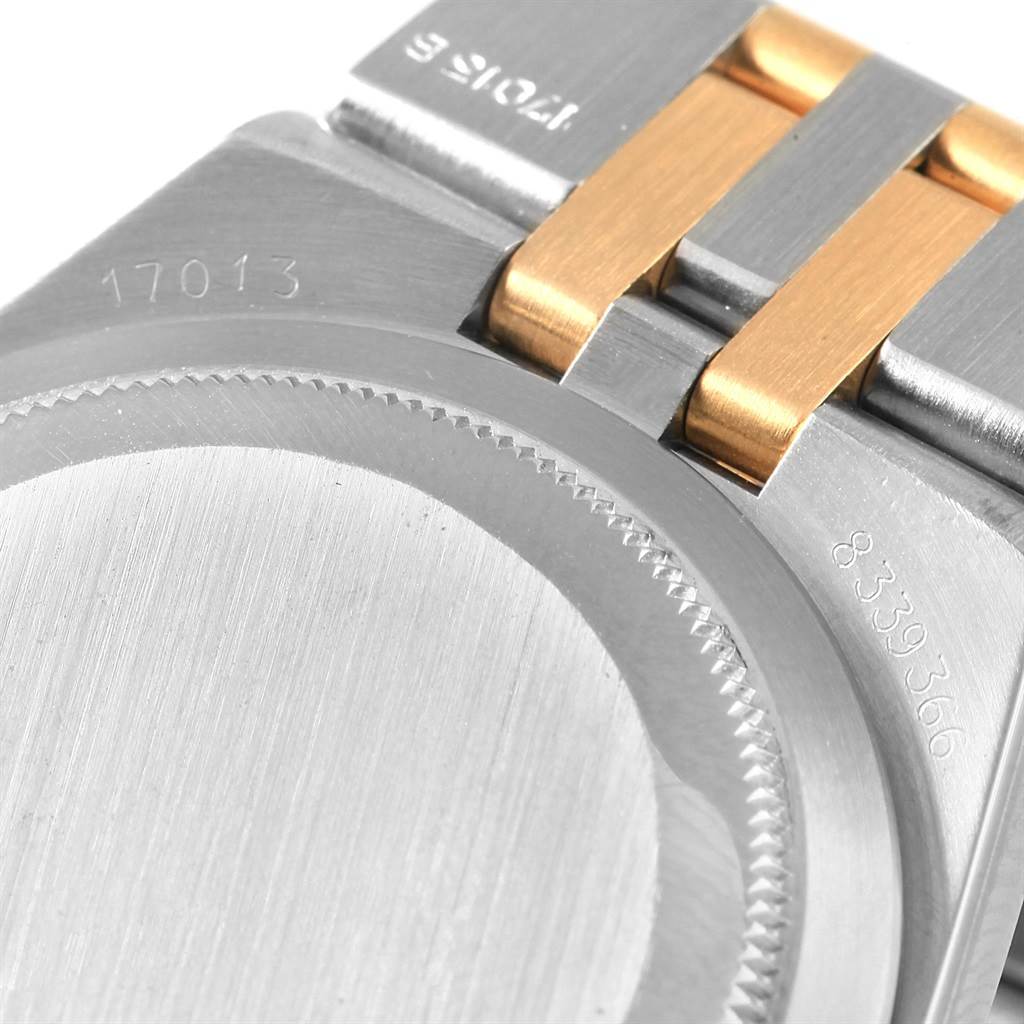 This image shows the back case and part of the bracelet of a Rolex Oysterquartz 17013 Men's Stainless Steel Champagne Dial 17013 Men's Stainless Steel Champagne Dial watch, revealing engravings and the two-tone design.