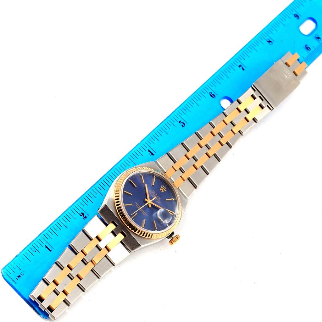 The Rolex Oysterquartz 17013 Men
s Stainless Steel Blue Dial 17013 Men
s Stainless Steel Blue Dial watch is shown from a top-down angle with its dial, case, and full bracelet visible.