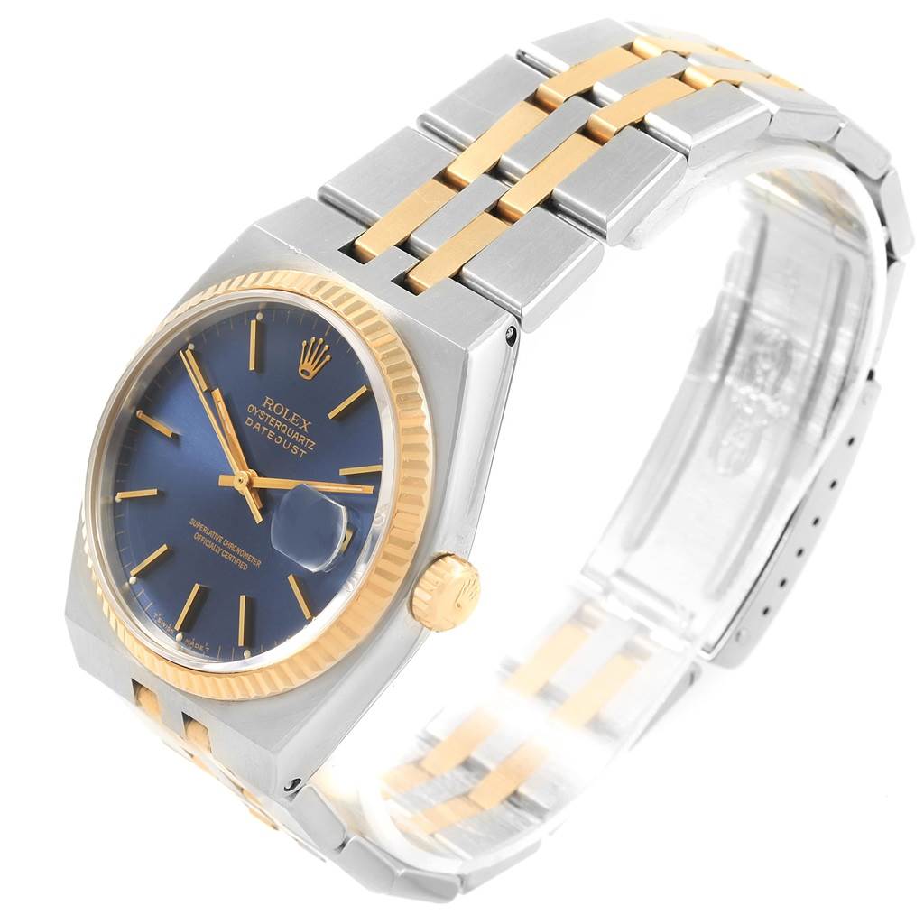This image shows a Rolex Oysterquartz 17013 Men
s Stainless Steel Blue Dial 17013 Men
s Stainless Steel Blue Dial watch at a three-quarter angle, highlighting the blue dial, gold bezel, and two-tone metal bracelet.