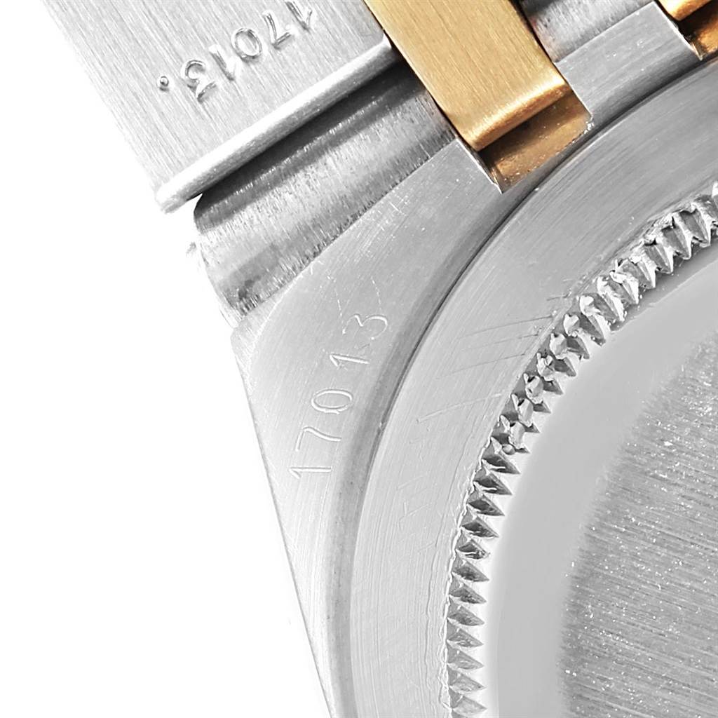 This close-up image shows the side of the Rolex Oysterquartz 17013 Men
s Steel and Gold (two tone) Blue Dial 17013 Men
s Steel and Gold (two tone) Blue Dial model, focusing on the serial numbers and part of the metal bracelet.
