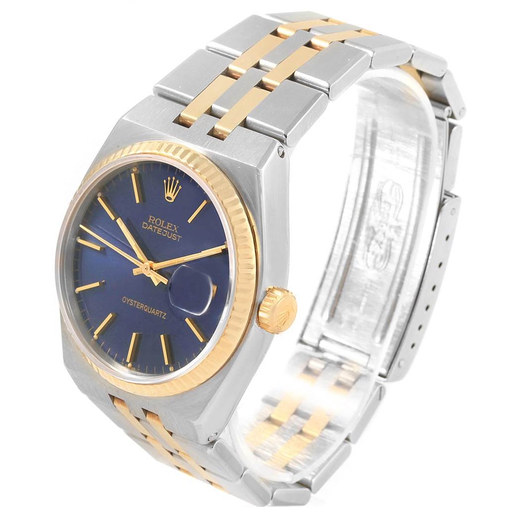 The Rolex Oysterquartz 17013 Men
s Steel and Gold (two tone) Blue Dial 17013 Men
s Steel and Gold (two tone) Blue Dial watch is shown at an angle, highlighting its blue dial, gold bezel, and two-tone bracelet.