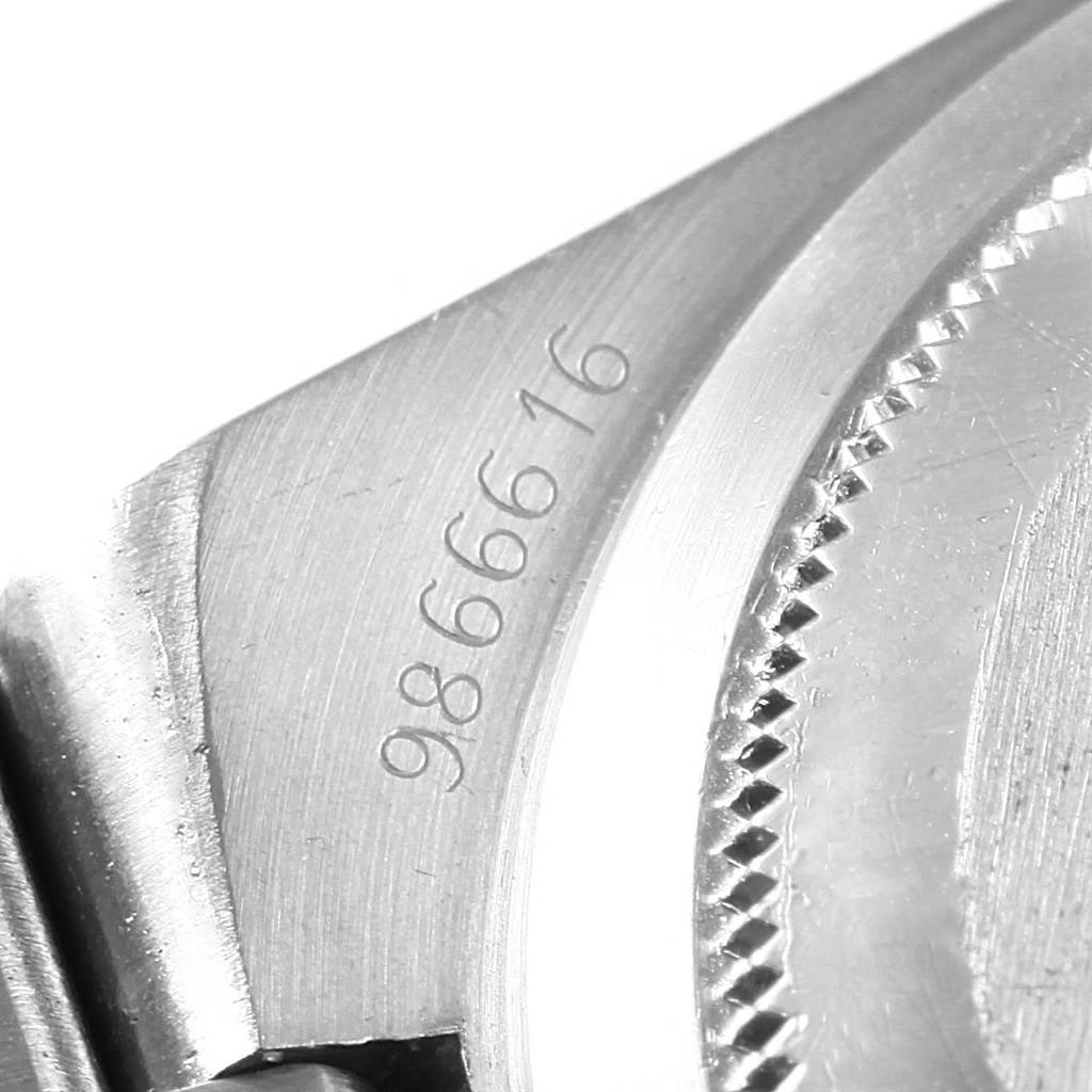 This close-up image of a Rolex Oysterquartz 17013 Men's Stainless Steel Champagne Dial 17013 Men's Stainless Steel Champagne Dial watch shows part of the case with its serial number engraving.