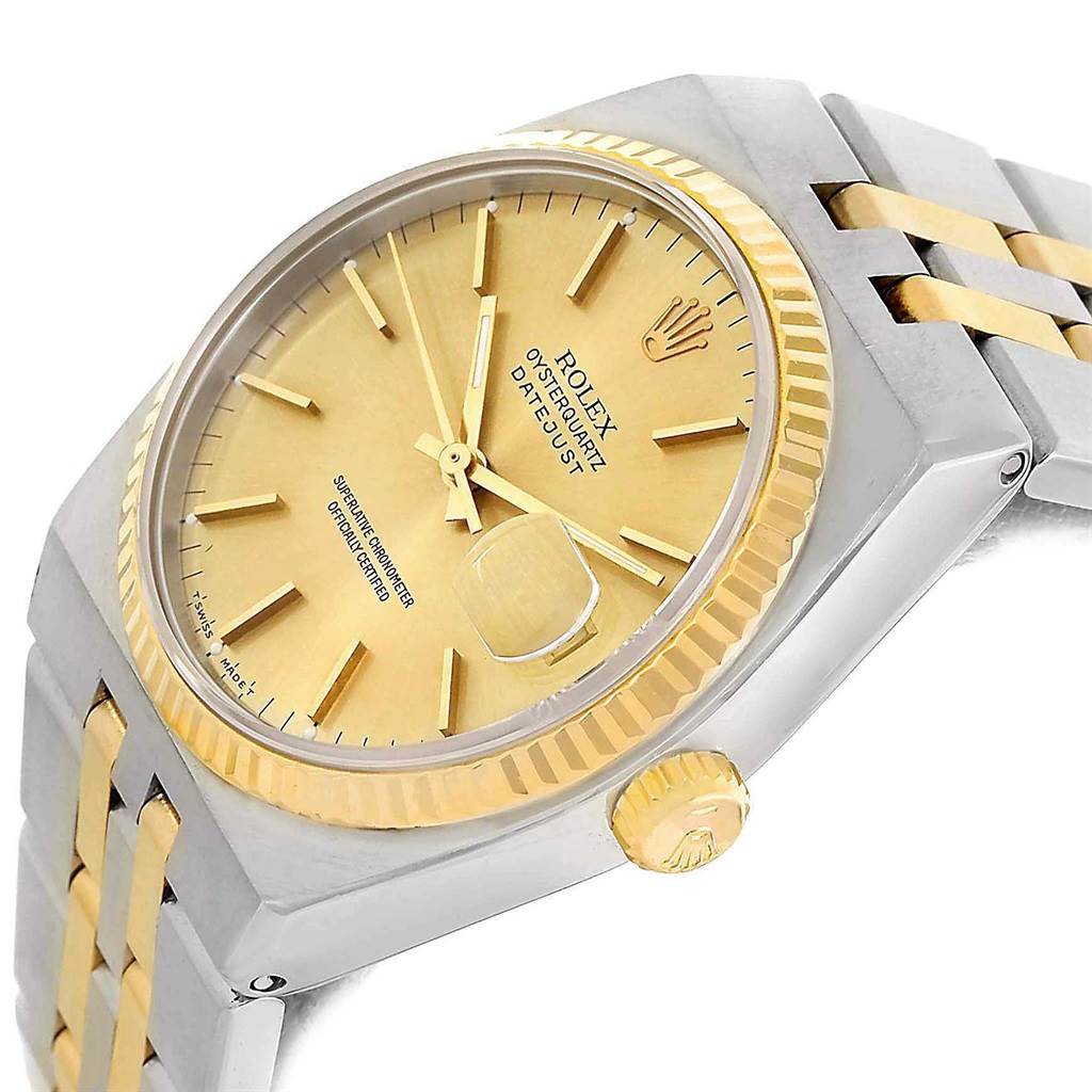 This image shows a close-up, angled view of the Rolex Oysterquartz 17013 Men's Stainless Steel Champagne Dial 17013 Men's Stainless Steel Champagne Dial watch, highlighting the gold dial, bezel, and two-tone bracelet.