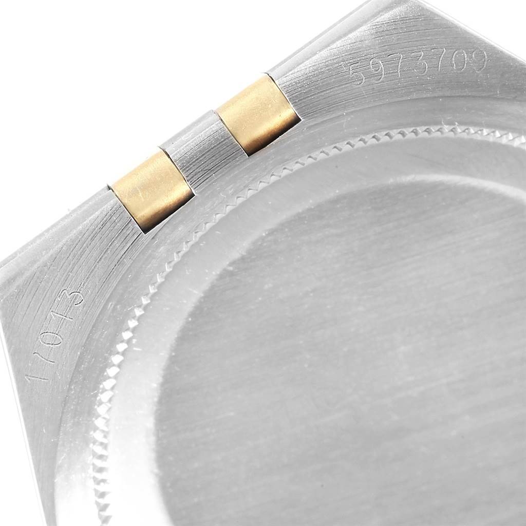 The image shows a close-up of the back case and part of the bracelet links of a Rolex Oysterquartz 17013 Men's Steel and Gold (two tone) White Dial 17013 Men's Steel and Gold (two tone) White Dial watch.