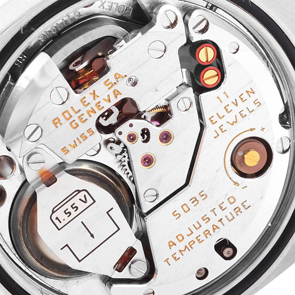 This image shows a close-up view of the internal mechanism of a Rolex Oysterquartz 17013 Men's Stainless Steel Black Dial 17013 Men's Stainless Steel Black Dial watch, highlighting the intricate components and inscriptions.