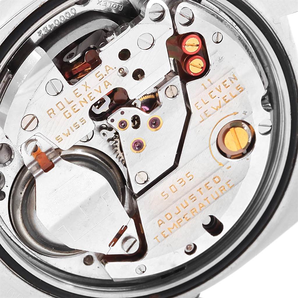 The image shows a close-up view of the internal mechanics of a Rolex Oysterquartz 17000 Men's Stainless Steel Black Dial 17000 Men's Stainless Steel Black Dial watch, highlighting the movement and components.